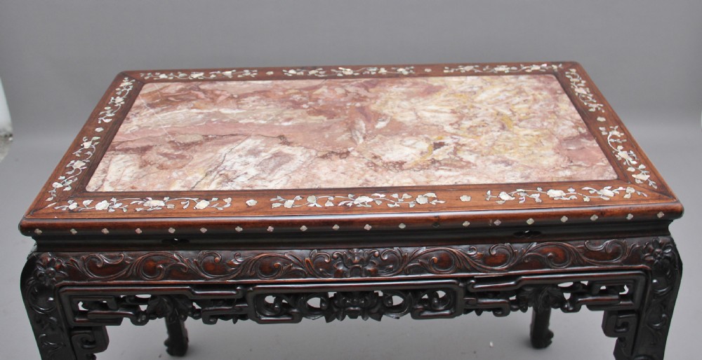 A dark carved hardwood Chinese centre table with an inset marble top and mother-of-pearl inlay along the frame. View VI