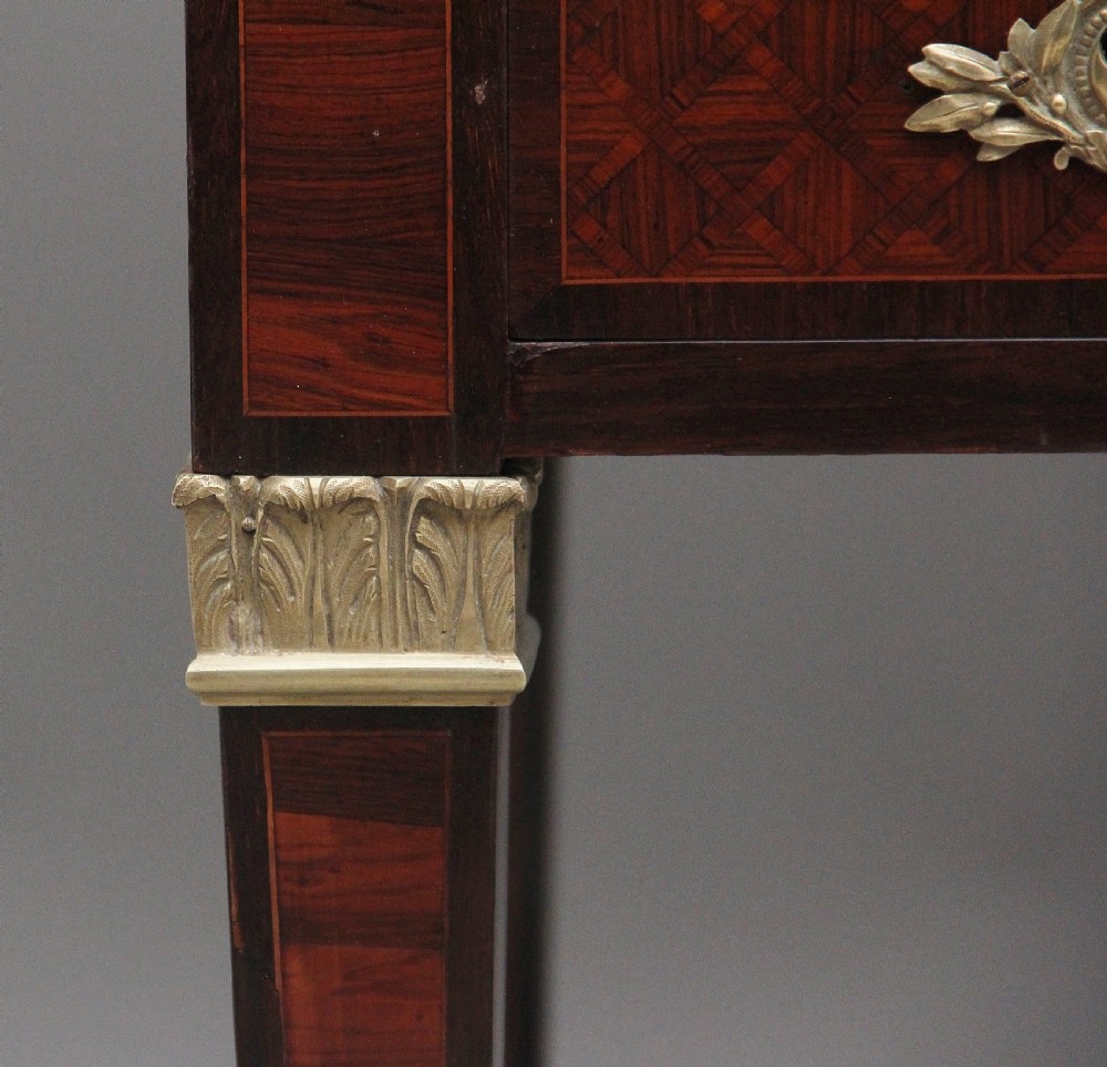 A 19th-century French kingwood cylinder desk featuring parquetry veneering, gilt-brass mounts, tapered square legs, and a curved roll-top section over multiple small drawers. View XV