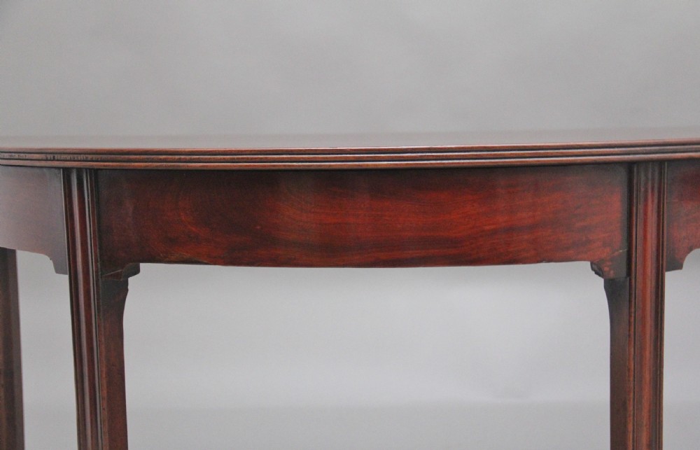 A fine pair of early 19th Century mahogany demi-lune console tables View VIII