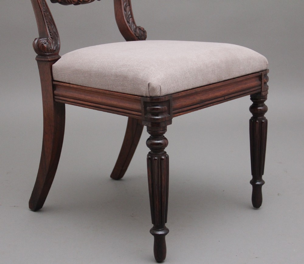 A set of six carved dark rosewood dining chairs with neutral fabric upholstered seats and padded backs. View VII