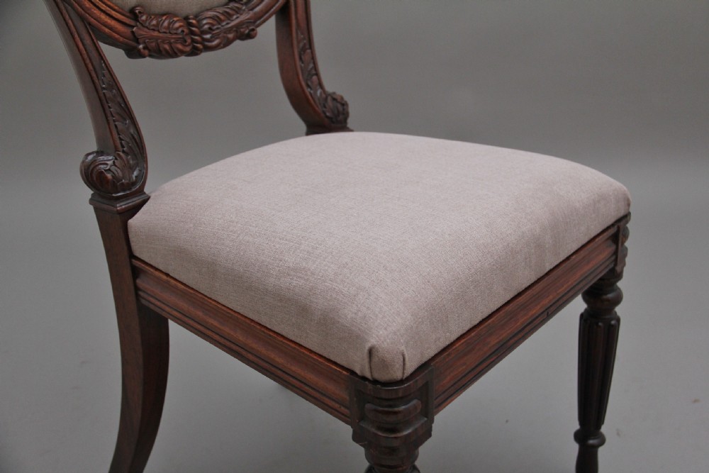 A set of six carved dark rosewood dining chairs with neutral fabric upholstered seats and padded backs. View IX