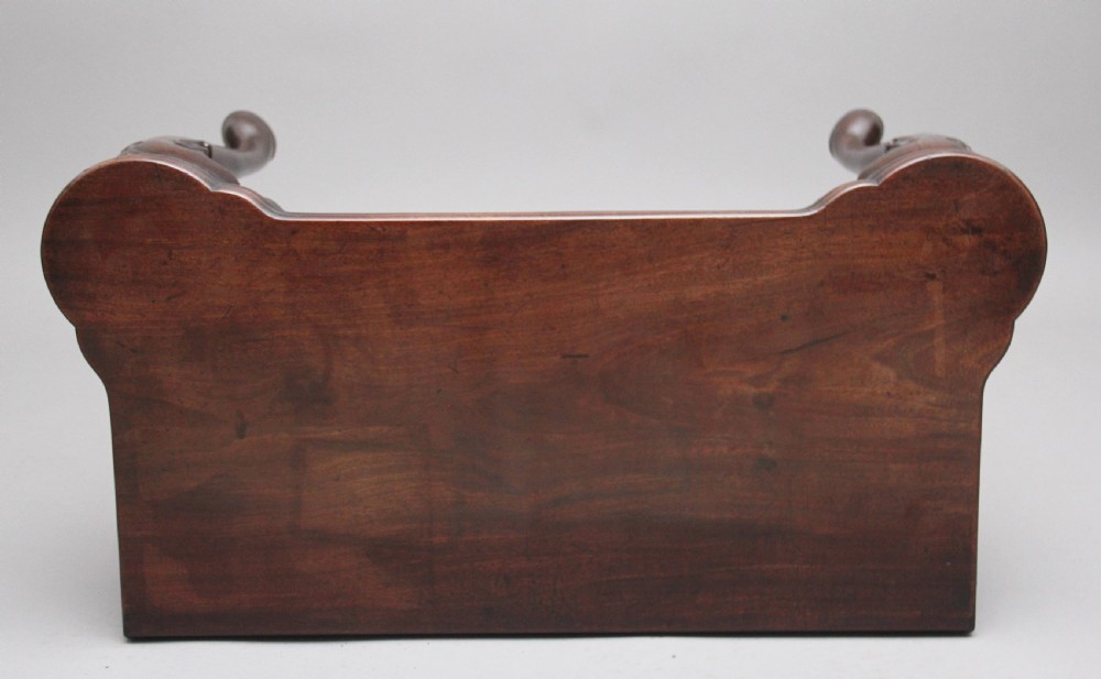 An 18th-century dark mahogany games table with a fold-over top, shell-carved cabriole legs, pad feet, and a central drawer. View X