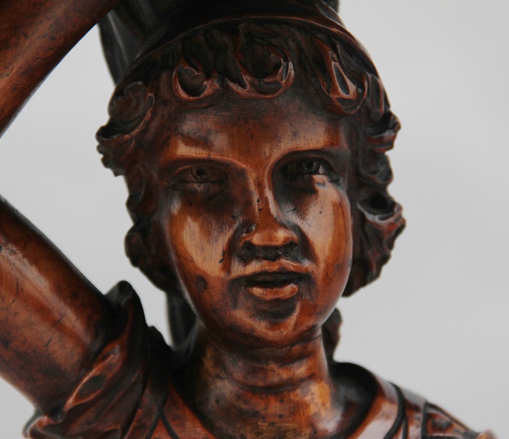 A dark carved wood Venetian figure stand featuring a gondolier holding an oar on a gondola hull, supporting a fringed draped tray surface. View X