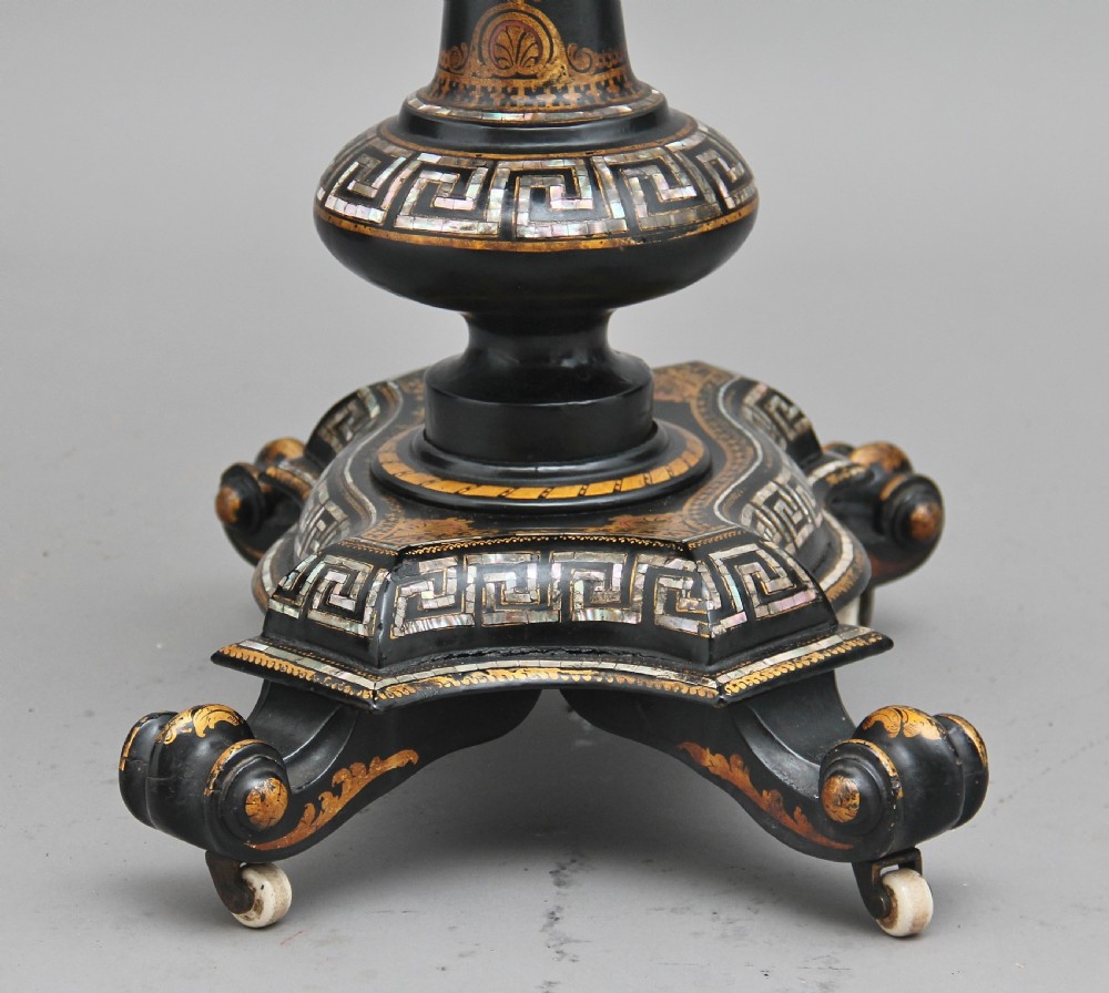 A nineteenth-century black lacquered papier-mache work table featuring mother-of-pearl Greek key inlay, hand-gilded detailing, a hinged box top, and a pedestal base on castors. View VIII