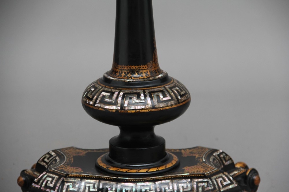 A nineteenth-century black lacquered papier-mache work table featuring mother-of-pearl Greek key inlay, hand-gilded detailing, a hinged box top, and a pedestal base on castors. View IX