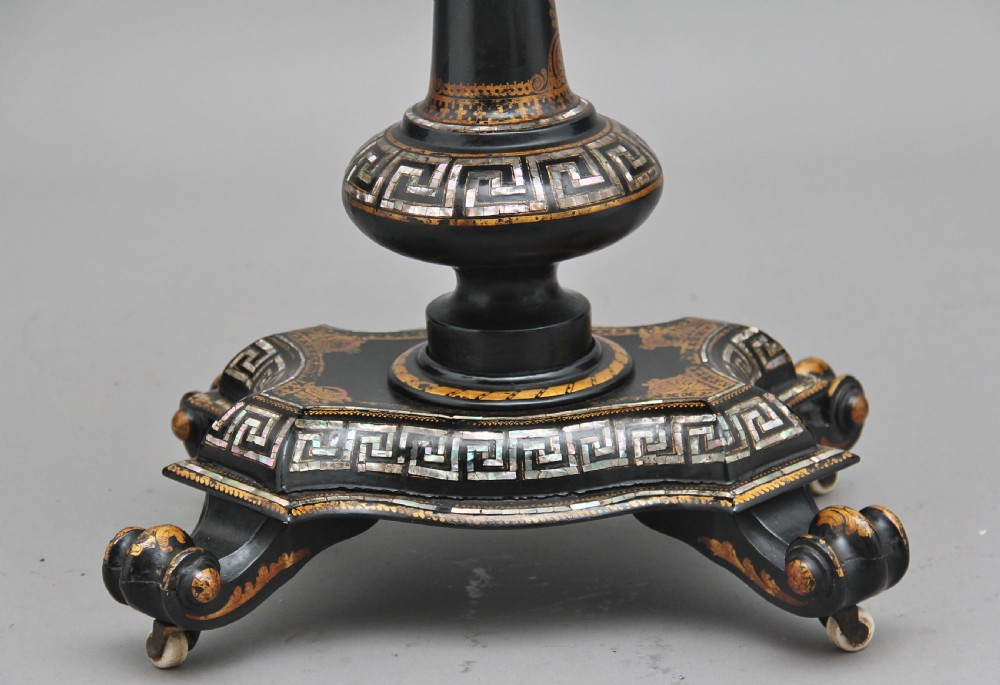 A nineteenth-century black lacquered papier-mache work table featuring mother-of-pearl Greek key inlay, hand-gilded detailing, a hinged box top, and a pedestal base on castors. View XI