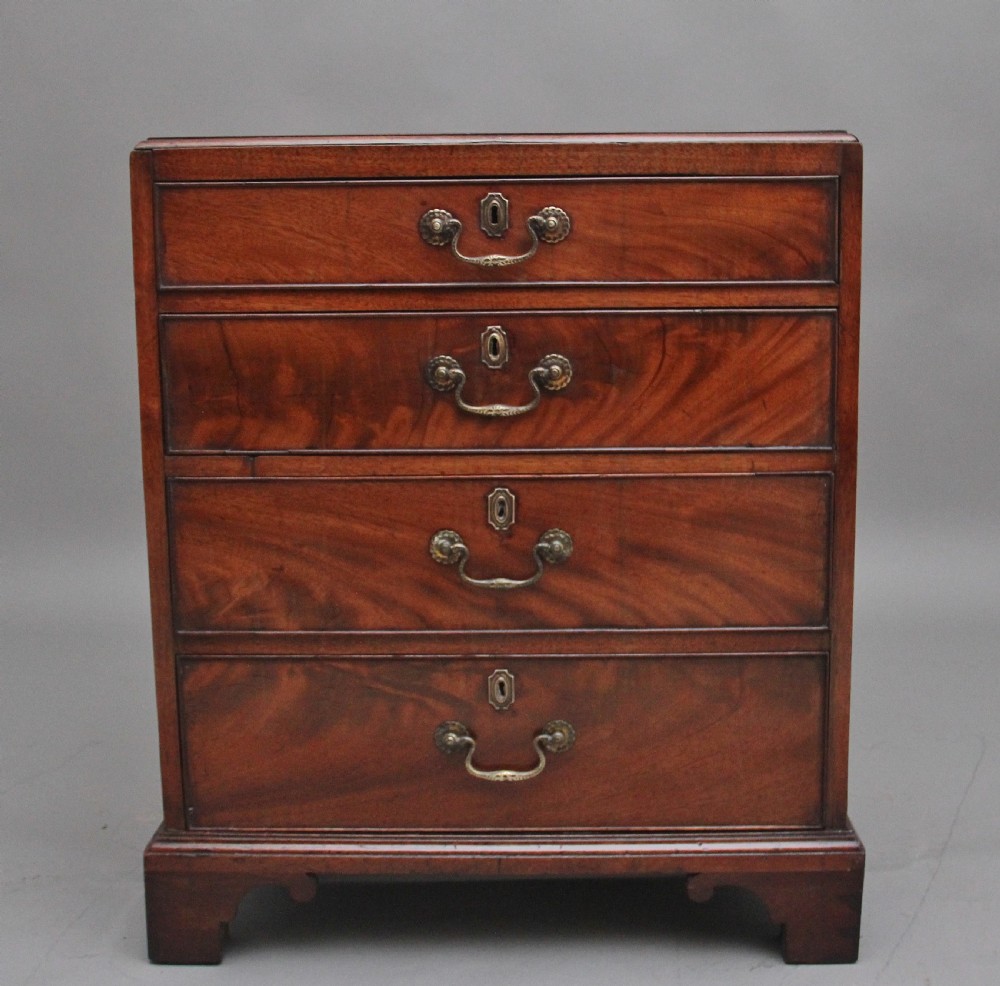 A nineteenth-century mahogany chest of drawers with four brass-handled drawers resting on bracket feet.