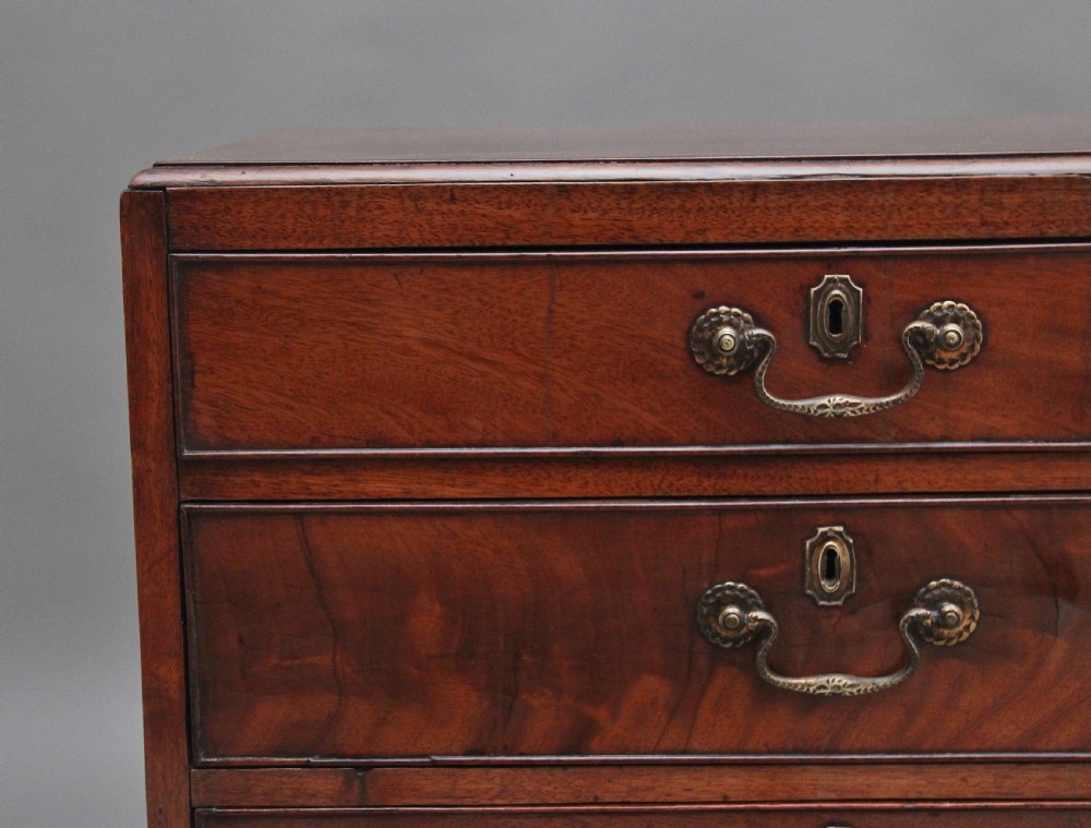 A nineteenth-century mahogany chest of drawers with four brass-handled drawers resting on bracket feet. View II
