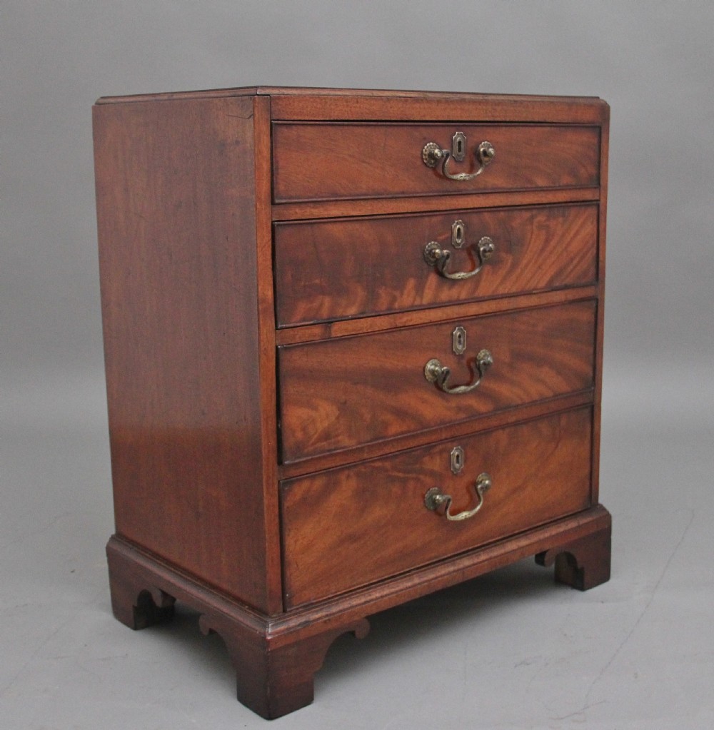 A nineteenth-century mahogany chest of drawers with four brass-handled drawers resting on bracket feet. View III