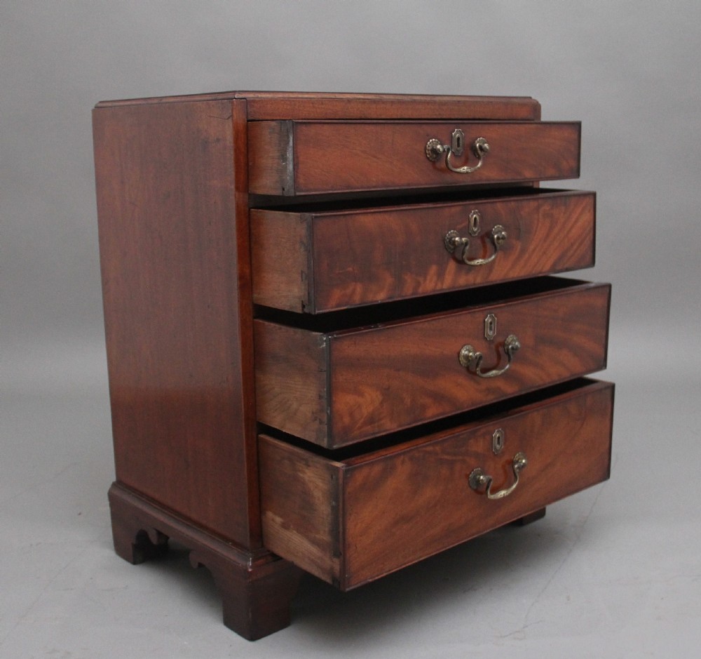 A nineteenth-century mahogany chest of drawers with four brass-handled drawers resting on bracket feet. View IV