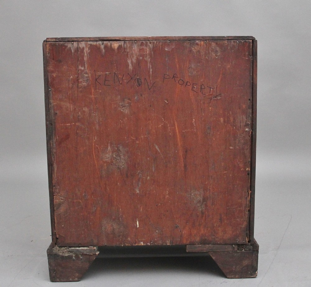 A nineteenth-century mahogany chest of drawers with four brass-handled drawers resting on bracket feet. View VII