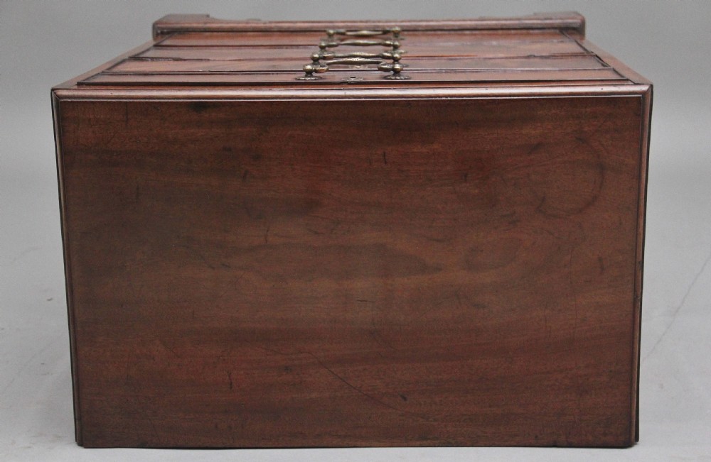 A nineteenth-century mahogany chest of drawers with four brass-handled drawers resting on bracket feet. View IX