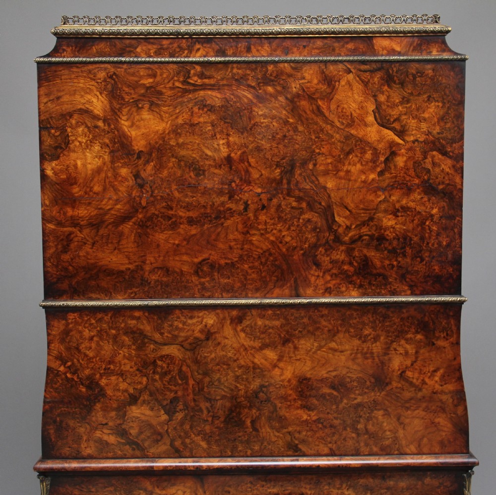 A nineteenth-century French walnut and kingwood bureau de dame with floral marquetry inlay, brass mounts, cabriole legs, and an upper cabinet with mirrored doors. View VII