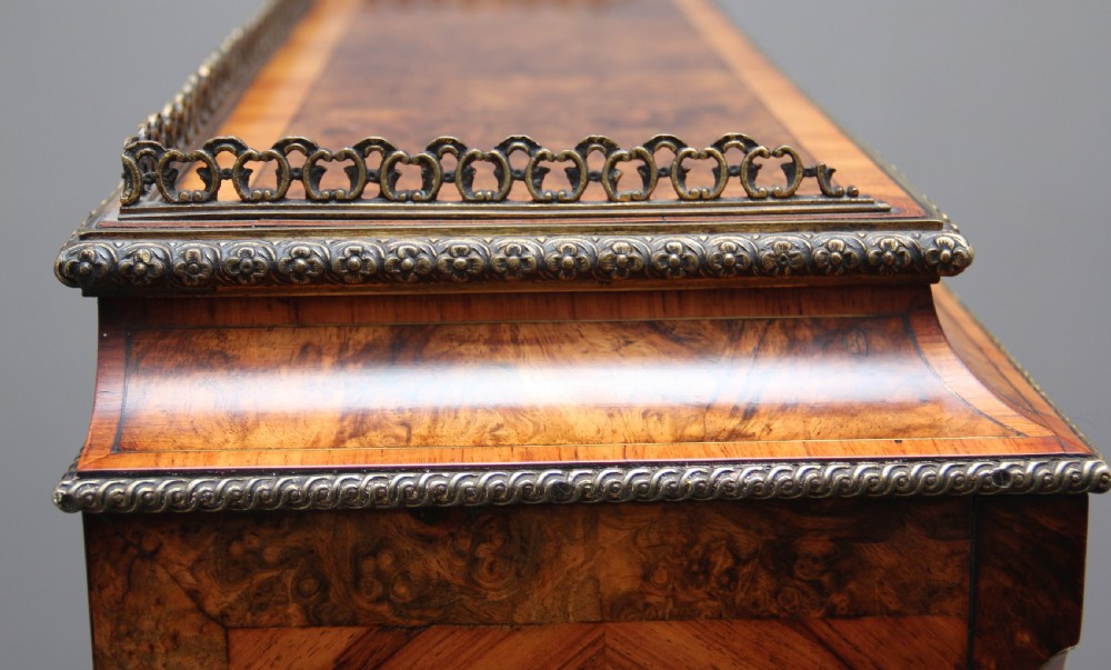 A nineteenth-century French walnut and kingwood bureau de dame with floral marquetry inlay, brass mounts, cabriole legs, and an upper cabinet with mirrored doors. View XVI