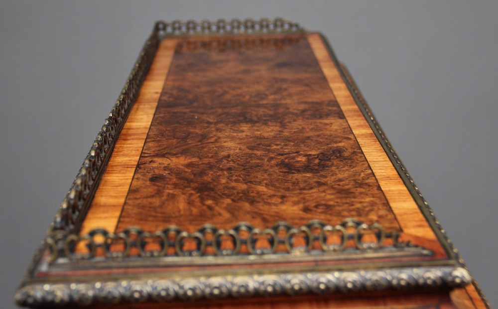 A nineteenth-century French walnut and kingwood bureau de dame with floral marquetry inlay, brass mounts, cabriole legs, and an upper cabinet with mirrored doors. View XVII