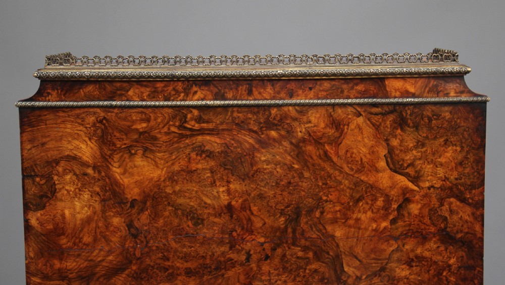 A nineteenth-century French walnut and kingwood bureau de dame with floral marquetry inlay, brass mounts, cabriole legs, and an upper cabinet with mirrored doors. View XVIII
