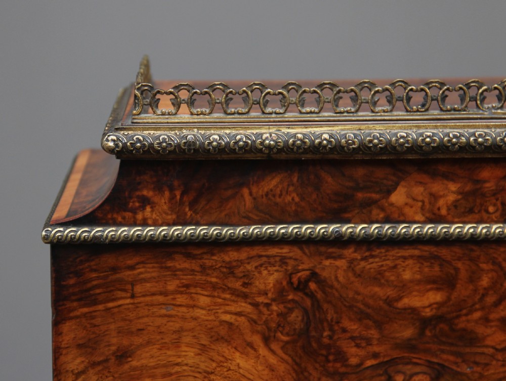 A nineteenth-century French walnut and kingwood bureau de dame with floral marquetry inlay, brass mounts, cabriole legs, and an upper cabinet with mirrored doors. View XIX