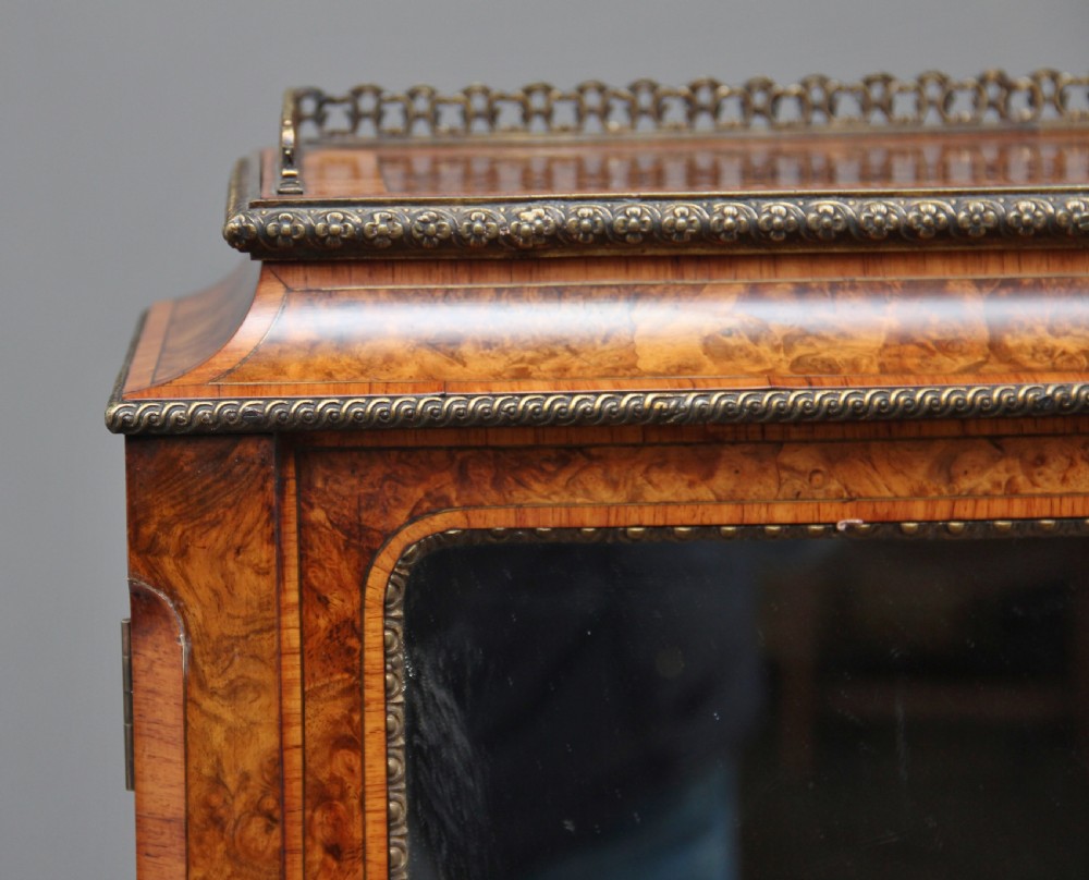 A nineteenth-century French walnut and kingwood bureau de dame with floral marquetry inlay, brass mounts, cabriole legs, and an upper cabinet with mirrored doors. View XXIII