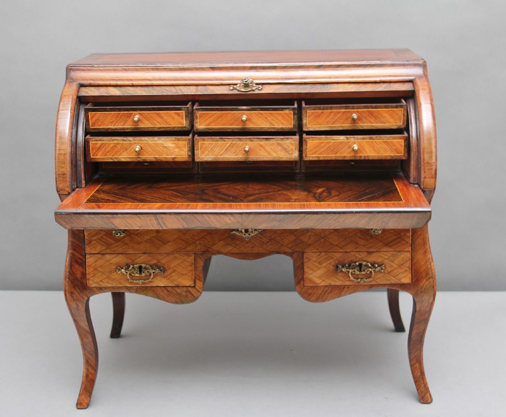 A 19th-century miniature walnut desk with geometric parquetry pattern, a cylinder roll top, cabriole legs, and brass handles. View III
