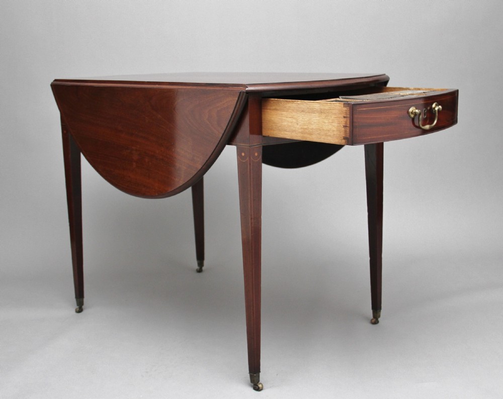 An 18th-century mahogany Pembroke table with two drop leaves, a single frieze drawer with a brass handle, boxwood stringing inlay, and square tapered legs on brass castors. View II