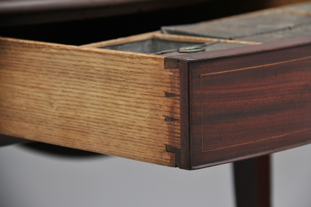 An 18th-century mahogany Pembroke table with two drop leaves, a single frieze drawer with a brass handle, boxwood stringing inlay, and square tapered legs on brass castors. View III