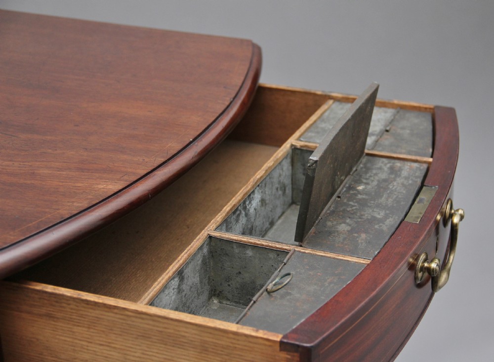 An 18th-century mahogany Pembroke table with two drop leaves, a single frieze drawer with a brass handle, boxwood stringing inlay, and square tapered legs on brass castors. View V
