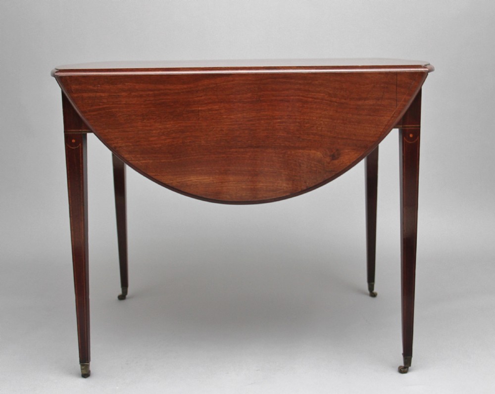 An 18th-century mahogany Pembroke table with two drop leaves, a single frieze drawer with a brass handle, boxwood stringing inlay, and square tapered legs on brass castors. View VIII