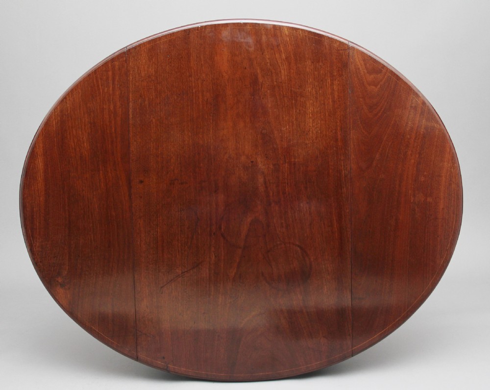 An 18th-century mahogany Pembroke table with two drop leaves, a single frieze drawer with a brass handle, boxwood stringing inlay, and square tapered legs on brass castors. View XI