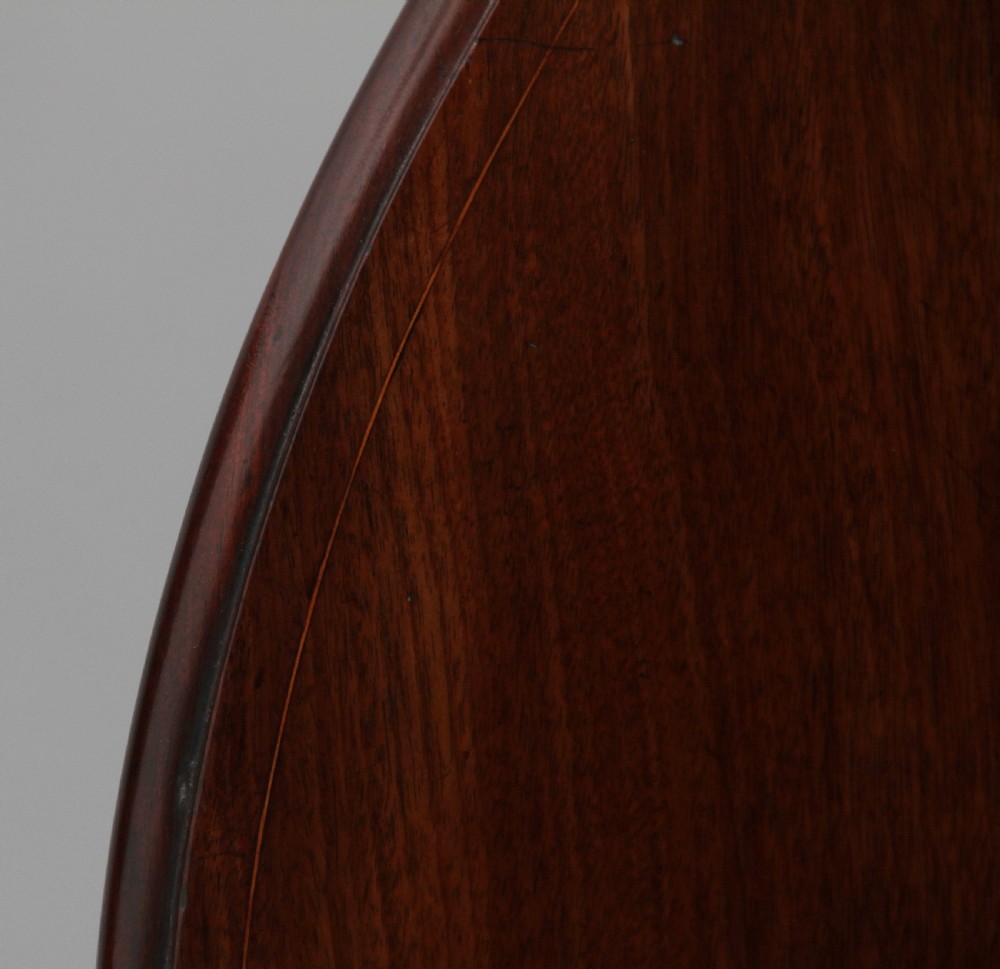 An 18th-century mahogany Pembroke table with two drop leaves, a single frieze drawer with a brass handle, boxwood stringing inlay, and square tapered legs on brass castors. View XII