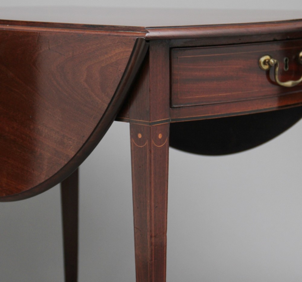 An 18th-century mahogany Pembroke table with two drop leaves, a single frieze drawer with a brass handle, boxwood stringing inlay, and square tapered legs on brass castors. View XIV