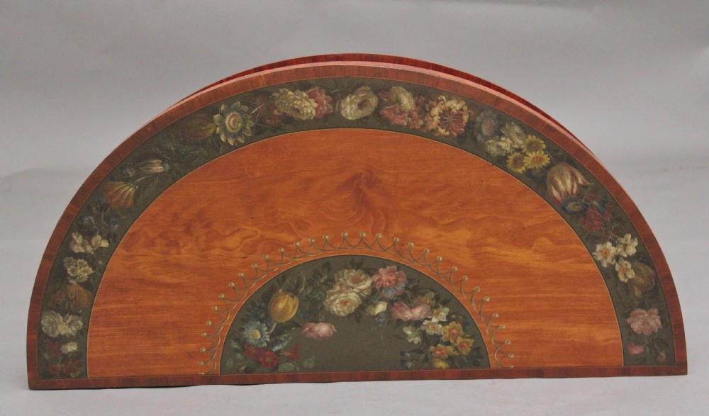 An early nineteenth-century demilune satinwood card table featuring hand-painted floral swags along the apron and slender tapered square legs. View XI