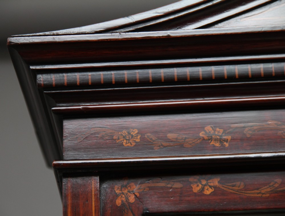 A 19th-century mahogany display cabinet featuring floral marquetry inlays, a glazed upper section with glass shelves, and a bow-front lower cabinet on tapered legs. View XIV