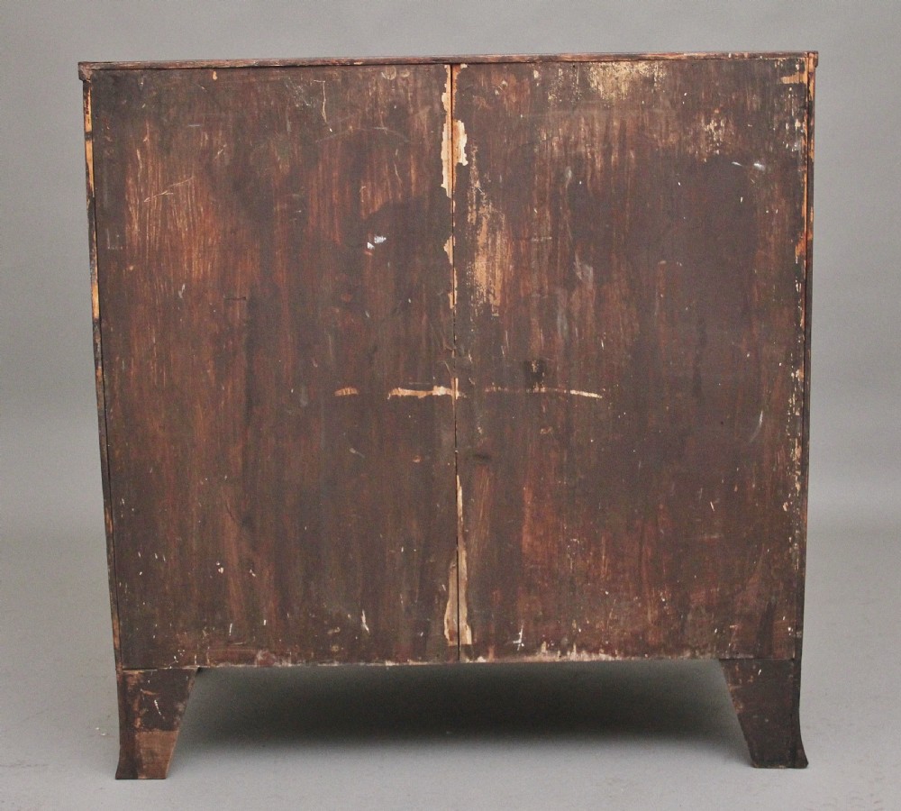 An 18th-century bowfront mahogany chest featuring four graduated drawers with oval brass ring handles, decorative inlay, and splayed bracket feet. View VIII