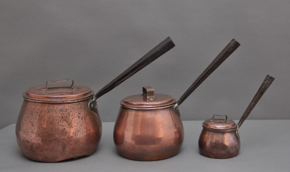 A set of three Victorian copper saucepans View II