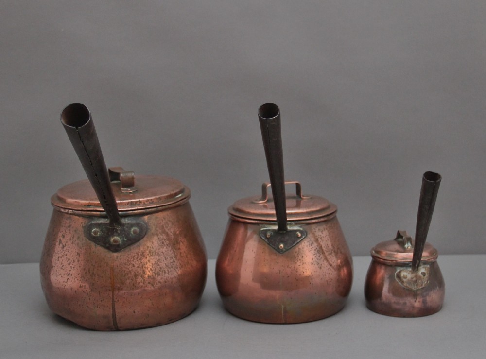 A set of three Victorian copper saucepans View III