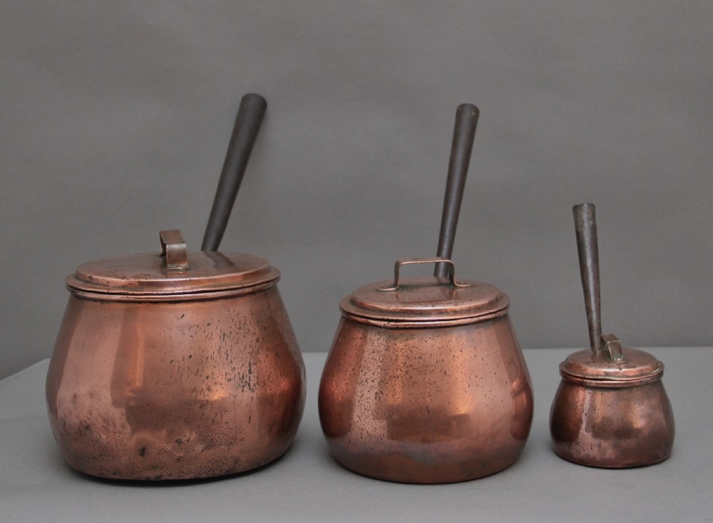 A set of three Victorian copper saucepans View V