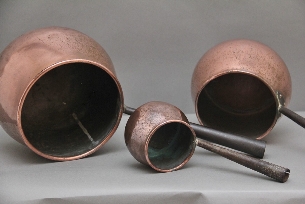 A set of three Victorian copper saucepans View VII