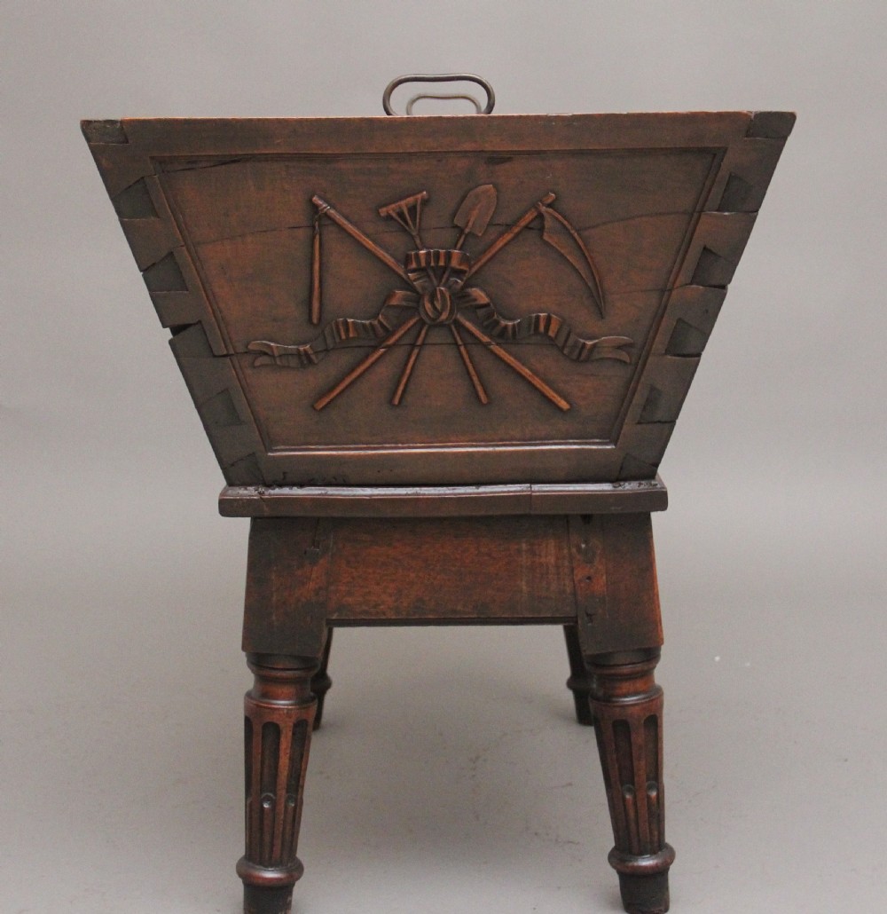 An 18th-century French carved walnut wine cooler featuring a zinc-lined tapered basin set on a stand with fluted legs and ribbon relief carvings. View IX