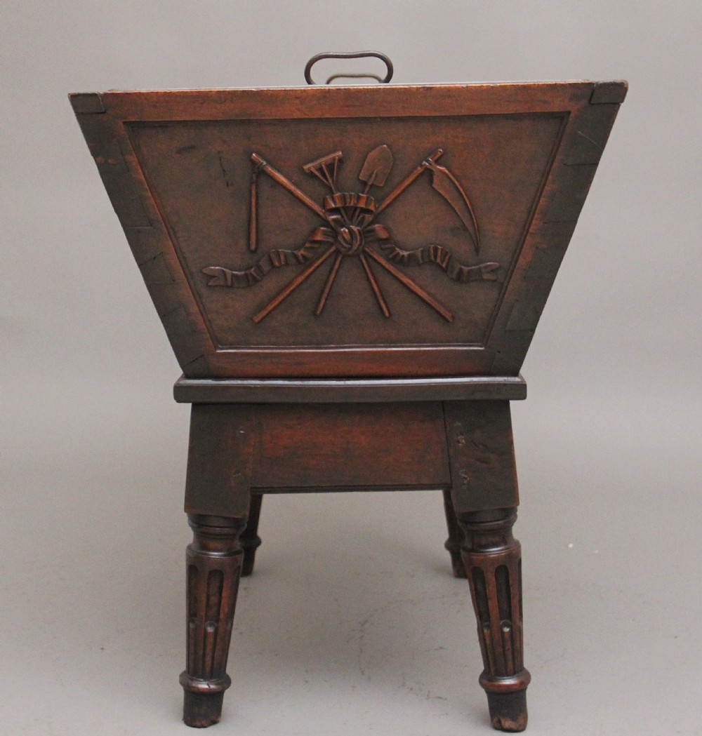 An 18th-century French carved walnut wine cooler featuring a zinc-lined tapered basin set on a stand with fluted legs and ribbon relief carvings. View XI