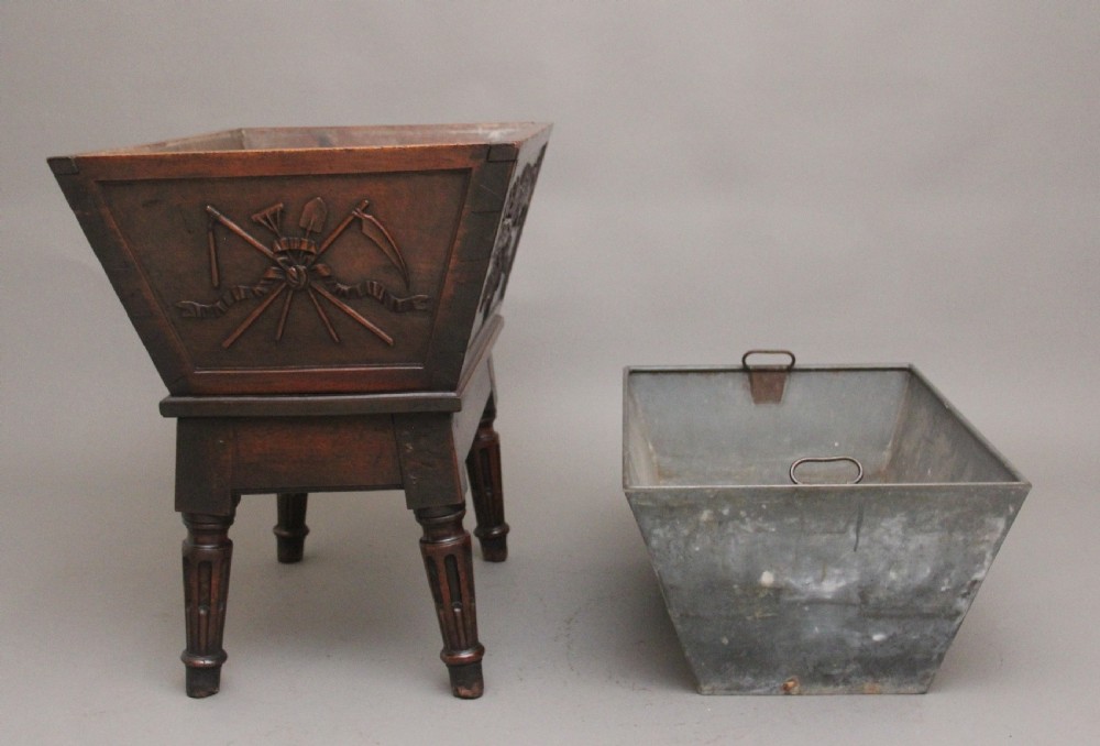 An 18th-century French carved walnut wine cooler featuring a zinc-lined tapered basin set on a stand with fluted legs and ribbon relief carvings. View XII