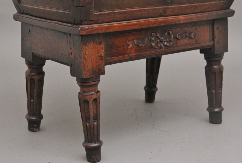 An 18th-century French carved walnut wine cooler featuring a zinc-lined tapered basin set on a stand with fluted legs and ribbon relief carvings. View XIII