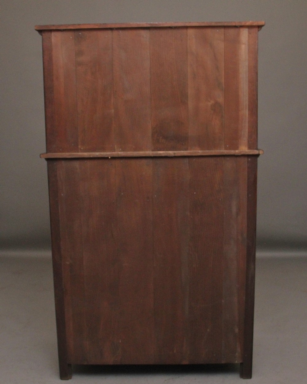 A carved dark oak court cupboard featuring arcaded door panels, turned bulbous supports, and geometric inlay details. View XI