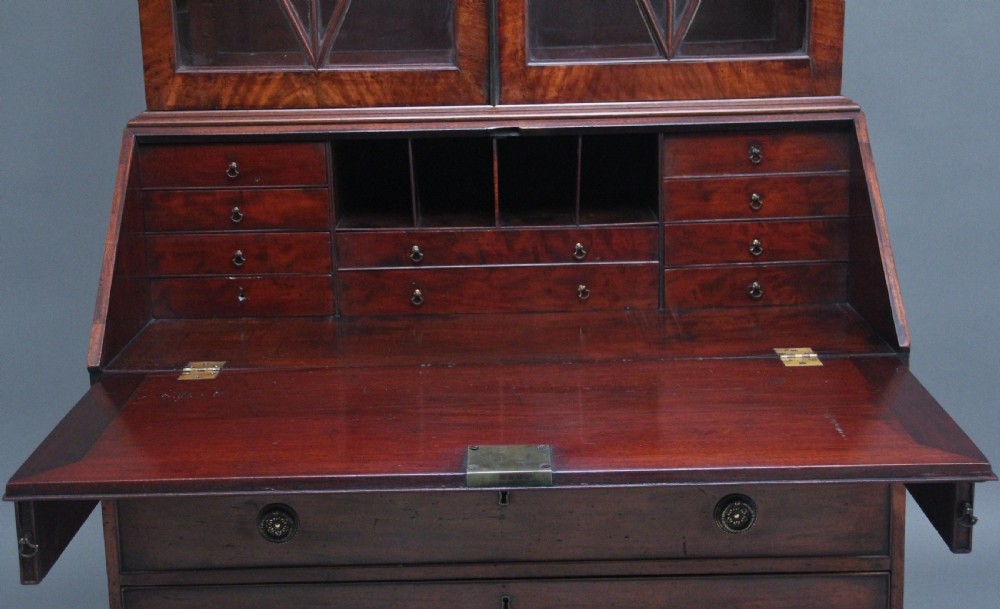 An early nineteenth-century mahogany bureau bookcase featuring a swan-neck pediment, diamond astragal glazed upper doors, a slant-front writing flap, and four graduated drawers. View VIII