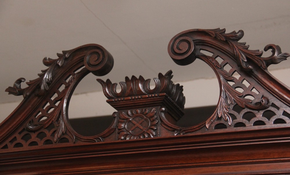 An early nineteenth-century mahogany bureau bookcase featuring a swan-neck pediment, diamond astragal glazed upper doors, a slant-front writing flap, and four graduated drawers. View XII