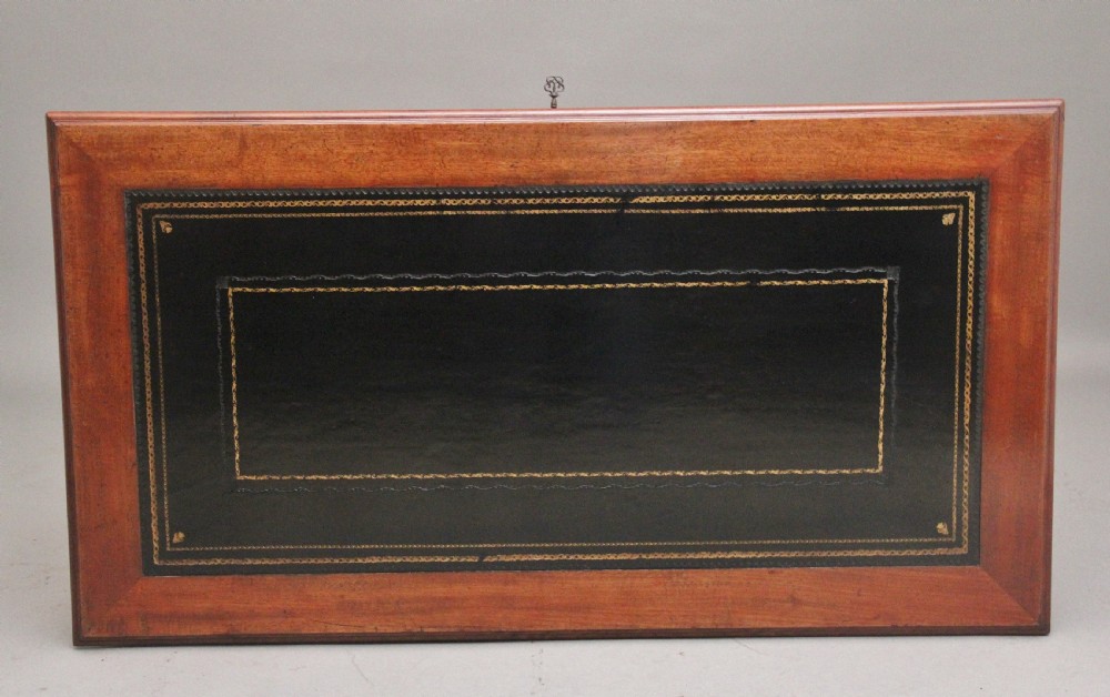 A 19th-century mahogany writing table featuring two frieze drawers with brass ring drop handles, supported by four turned and reeded legs. View III