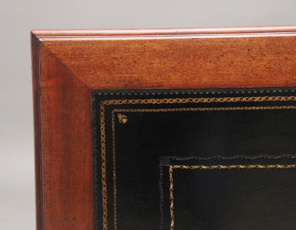 A 19th-century mahogany writing table featuring two frieze drawers with brass ring drop handles, supported by four turned and reeded legs. View IV