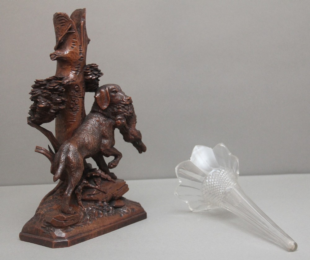 A nineteenth-century carved dark wood Black Forest centrepiece featuring a hunting dog holding game beneath a clear cut-glass trumpet vase. View VII