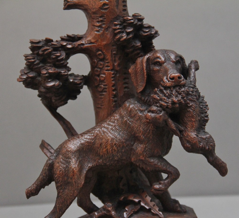 A nineteenth-century carved dark wood Black Forest centrepiece featuring a hunting dog holding game beneath a clear cut-glass trumpet vase. View IX
