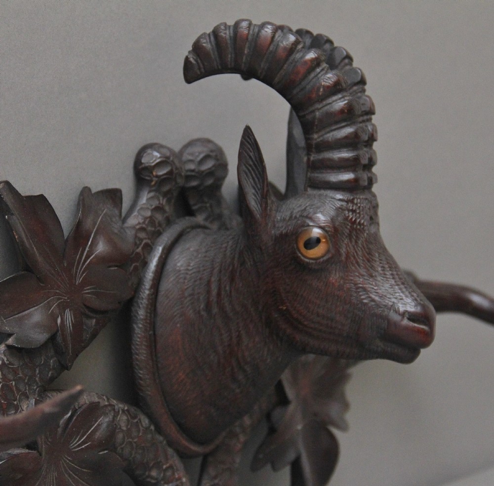 A nineteenth-century carved dark wood Black Forest centrepiece featuring a hunting dog holding game beneath a clear cut-glass trumpet vase. View XII