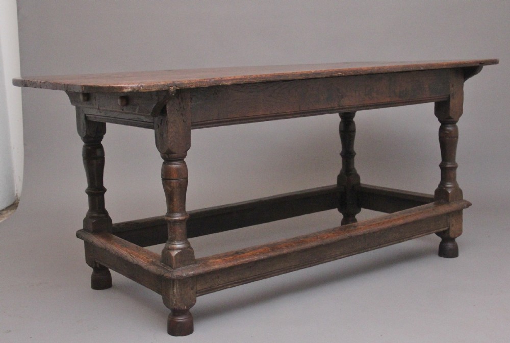 A 17th-century oak refectory table featuring a plank top, turned legs, and a perimeter box stretcher base. View II